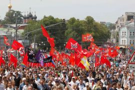 Participants march with flags and placards during an anti-government protest in Moscow June 12, 2012. Thousands of Russians said they would defy Kremlin pressure and attend a march in Moscow on Tuesday to protest against President Vladimir Putin, shrugging off his tough new tactics to quash any challenge to his rule. REUTERS