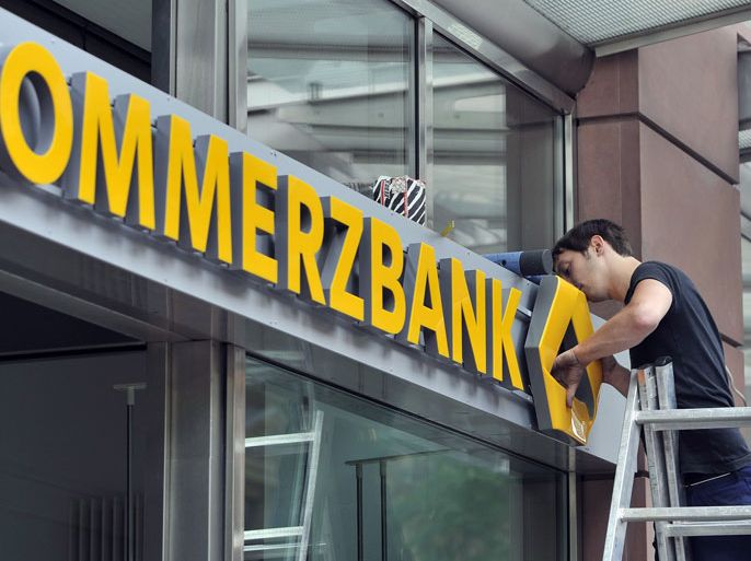 epa02992379 (FILE) A file photo dated 15 June 2010 showing a worker attaching the new Commerzbank logo at a bank's branch in Frankfurt Main, Germany. Shares in Commerzbank fell on 04 November 2011 by about 4 per cent after Germany's second biggest bank said that it slumped into a loss during the third quarter after writing down its Greek debt holdings. The Frankfurt-based bank posted a net loss of 687 million euros (949.2 million dollars) in the three months ended September, compared with a 113 million-euro profit in the same period last year. The bank wrote down the value of its Greek government debt portfolio by 798 million euros reducing its exposure to the heavily indebted eurozone state to 1.4 billion euros. EPA/MARIUS BECKER Local Caption 00000402202975