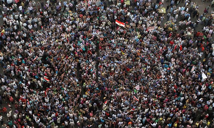 gyptian anti-Mubarak protesters raise an Egyptian flag during a rally in Cairo's landmark Tahrir square on June 3, 2012. Thousands of people protested in Cairo for a second day after the verdicts on June 2, handed Mubarak and his interior minister Habib al-Adly life in prison over the deaths of protesters but acquitted the police commanders. AFP