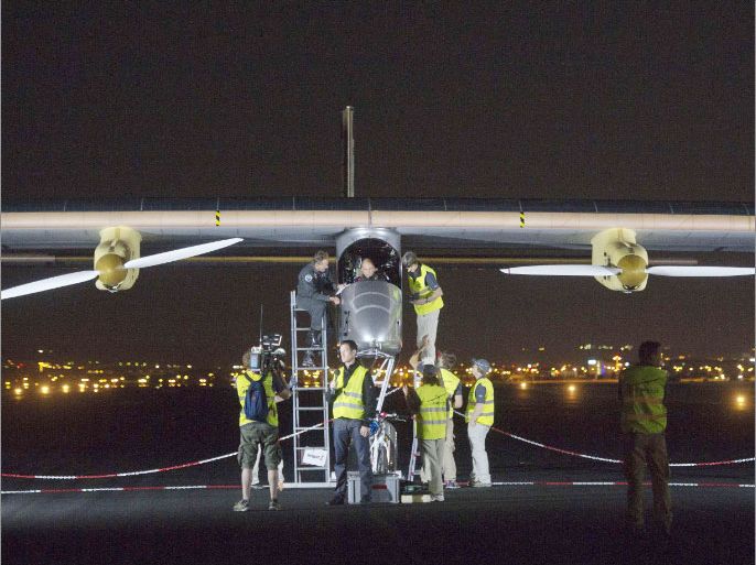 Crew members prepare the Swiss sun-powered aircraft Solar Impulse for take off on June 5, 2012 at the Barajas airpot in Madrid on its first attempted intercontinental flight from Switzerland to Morocco. A Swiss adventurer took off into the night skies above Madrid and headed for Rabat on the world's first intercontinental flight in a solar-powered plane. Bernard Piccard, 54-year-old psychiatrist and balloonist, piloted the Solar Impulse plane, a giant as big as an Airbus A340 but as light as an average family car, on the daring voyage from Europe to Africa. AFP PHOTO / DOMINIQUE FAGET