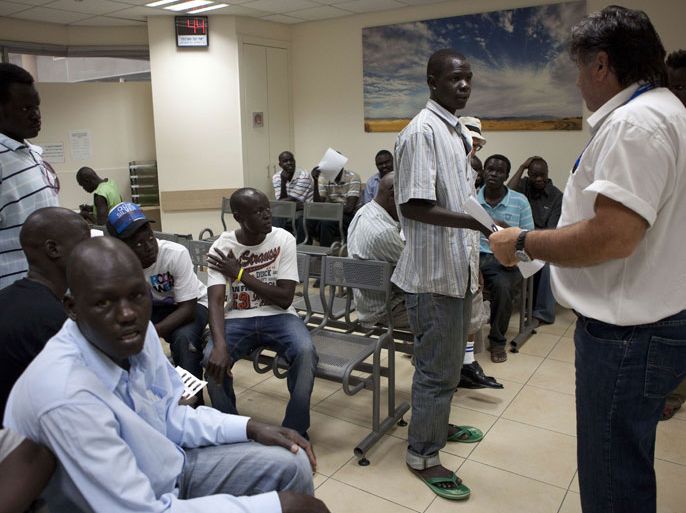 South Sudanese migrants receive instruction at the Immigration population Authority office in Eilat as they prepare to return to South Sudan, in southern Israeli city of Eilat June 12, 2012, where thousands of migrants reside