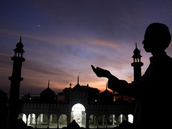 A Muslim devotee is praying after sighting the moon in the sky at the historical Moti Masjid Mosque, in Bhopal, India