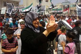 A woman claps her hands as demonstrators protest against Syria's President Bashar al-Assad at Binsh near Idlib July 6, 2012. REUTERS/Shaam News Network/Handout (SYRIA - Tags: POLITICS CIVIL UNREST) FOR EDITORIAL USE ONLY. NOT FOR SALE FOR MARKETING OR ADVERTISING CAMPAIGNS. THIS IMAGE HAS BEEN SUPPLIED BY A THIRD PARTY. IT IS DISTRIBUTED, EXACTLY AS RECEIVED BY REUTERS, AS A SERVICE TO CLIENTS