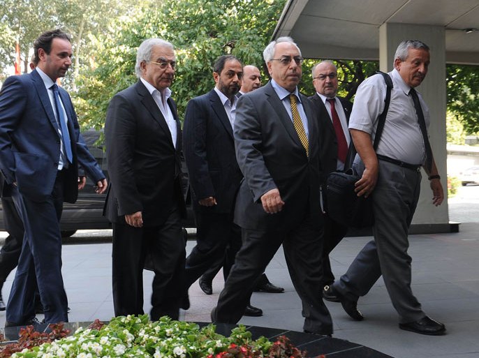 The members of the Syrian National Council and its head Abdulbaset Sieda (2-R) arrive for a meeting with Turkey's Foreign Minister Ahmet Davutoglu in Ankara on July 23, 2012. AFP PHOTO/STR