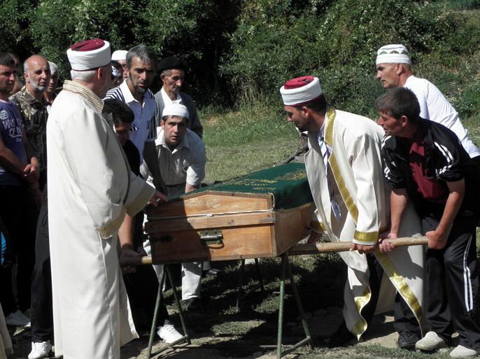 BULGARIA : Muslim clerics and relatives attend the funeral ceremony of the Bulgarian Muslim driver Mustafa Kyosov, who was killed in a suicide bombing in Burgas,in the village Yurukovo, some 200kms south of Sofia. Bulgarian police aided by the FBI and Interpol struggled to identify a suicide bomber 48 hours after he killed six people including five Israeli tourists, with authorities saying only he was a foreigner. AFP PHOTO / BGNES/ BOZHIDAR STOILOV