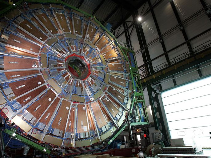 Geneva, Genève, SWITZERLAND : A woman stands on March 22, 2007 behind a layers of the world's largest superconducting solenoid magnet (CMS), one of the experiments preparing to take data at European Organization for Nuclear research (CERN)'s Large Hadron Collider (LHC) particule accelerator near Geneva. US-based physicists reported on July 3, 2012 finding strong hints of the Higgs boson, the elusive "God particle" believed to give objects mass, but said European data is needed to confirm any potential discovery.If physicists can confirm the existence of the Higgs boson, the last missing piece in the standard model of physics, the announcement would rank among the most important scientific breakthroughs of the last century. The final findings from Fermi National Accelerator Laboratory (Fermilab) in the midwestern US state of Illinois will be followed by the announcement of more definitive results from a potent European atom-smasher on July 4. AFP PHOTO / FABRICE COFFRINI