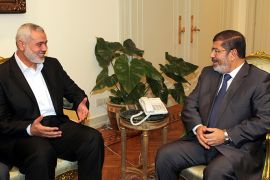 A handout picture released by the press office of Hamas shows Palestinian Hamas Gaza premier Ismail Haniya (L) speaking with Egypt's President Mohamed Morsi during his visit to Cairo on July 26, 2012. Haniya's visit to Cairo, the second by a top-ranking Hamas official since the Islamist Morsi's election last month, came days after Palestinian officials said Egypt had eased visa requirements for Gazans under 40. AFP