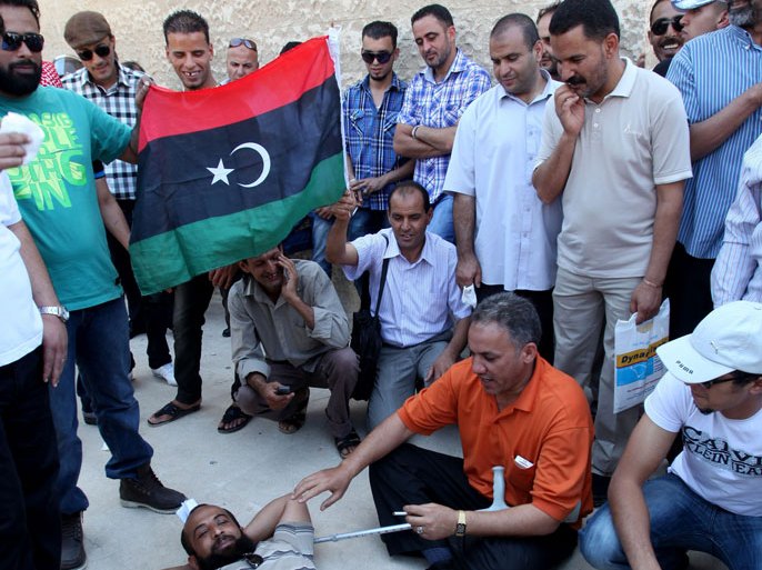 Libyan protesters gather outside the Libyan embassy in the Jordanian capital Amman on July 15, 2012 to demand their government to pay their medical bills and other expenses. AFP PHOTO/STR
