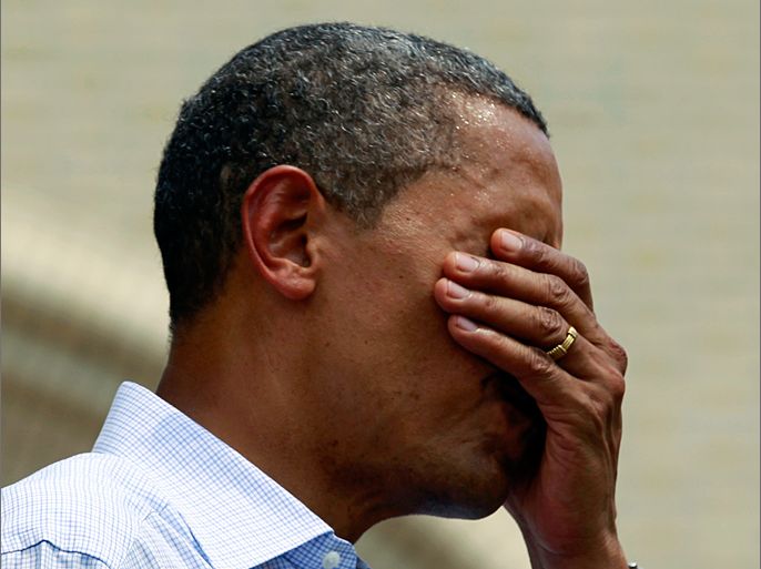 U.S. President Barack Obama wipes perspiration from his face while speaking at a campaign event at Carnegie Mellon University in Pittsburgh, Pennsylvania July 6, 2012. Obama is on a two-day campaign bus tour of Ohio and Pennsylvania.