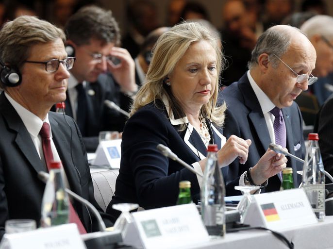 Secretary of State Hillary Clinton (C), German Foreign Minister Guido Westerwelle (L) and French Foreign Minister Laurent Fabius (R) listen during a meeting of the "Friends of the Syrian People" at the MFA Conference Center July 6, 2012 in Paris, France. The Syrian conflict has become a threat to international peace and security, French President Hollande told a Friends of Syria meeting today, appealing to Russia to back regime change