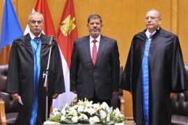 A handout picture released by the Egyptian Presidency shows President Mohamed Morsi (C) taking the oath of office in a swearing-in ceremony at the Constitutional Court in Cairo, Egypt, 30 June 2012. Islamist Mohammed Morsi was sworn on 30 June as Egypt's first freely elected civilian president, pledging to restore the rule of law. EPA/EGYPTIAN PRESIDENCY/HANDOUT HANDOUT EDITORIAL USE ONLY/NO SALES
