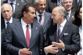 French Foreign Minister Laurent Fabius (R) speaks with Cheikh Hamad bin Jassem Al-Thani from Qatar (L) following a meeting of the "Friends of the Syrian People" with all his counterparts at the MFA Conference Center in Paris on July 6, 2012