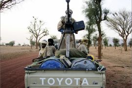 Title:Militiaman from the Ansar Dine Islamic group ride on an armed vehicle between Gao and Kidal in northeastern Mali