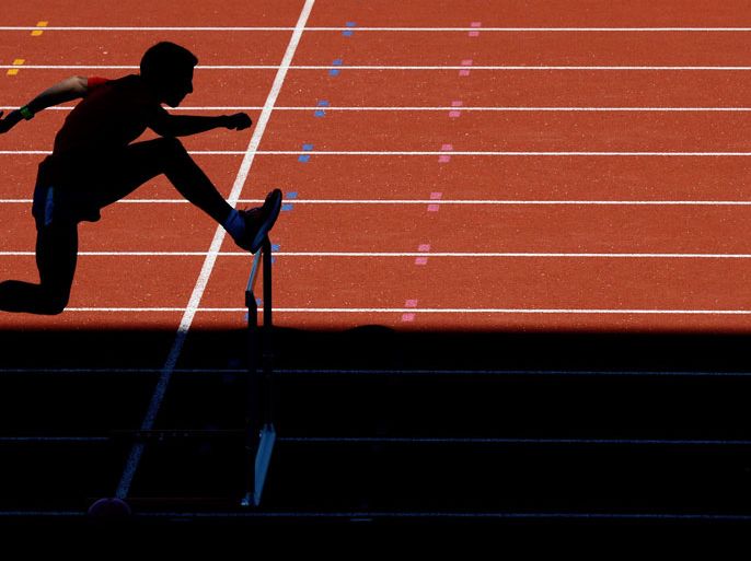 : US steeplechaser Donn Cabral practices hurdles during a training session at Alexander Stadium, the US Olympic athletics team training camp, in Birmingham on July 23, 2012 four days before the official start of the London 2012 Olympic Games. AFP PHOTO / ADRIAN DENNIS