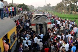 People gather at the scene of a train derailment in the Giza neighbourhood of Badrashin on the outskirts of Cairo July 17, 2012. The train was travelling from southern Egypt towards Cairo when it derailed in a Cairo suburb on Tuesday and 15 people were injured, security and medical officials said, denying early reports that passengers had died in the crash. REUTERS/Stringer (EGYPT - Tags: DISASTER TRANSPORT TPX IMAGES OF THE DAY)