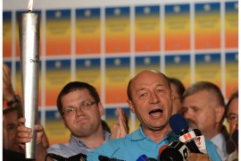 DAN031 - Bucharest, -, ROMANIA : Romanian President Traian Basescu holds The Democracy Torch as he addresses reporters at his electoral campaign headquarters in Bucharest July 29, 2012. Romanians vote on July 29 in a referendum regarding the impeachment of Romanian President Traian Basescu