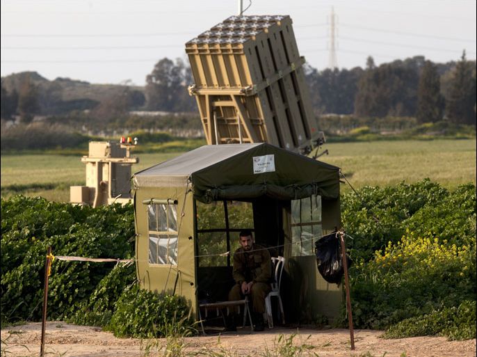 epa03139619 An Israeli soldier sits in a tent nearby a firing unit of the Iron Dome anti-missile missile systems somewhere in southern Israel, 10 March 2012. Palestinian militants have fired some 60 missiles and mortars into southern Israel in the past twenty-four hours and the Iron Dome has successfully hit at least 27 out of 29 Grad missile fired towards Israeli population centers such as Ashkelon, Ashdod and Beersheba. The missile attacks come after Israel targeted a senior leader of a Palestinian militant faction in the Gaza Strip and killed two militants on 09 March. EPA/JIM HOLLANDER