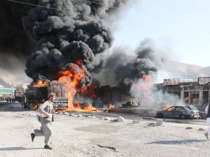 Flames rise from an oil tanker reportedly carrying oil for NATO forces, after it was attacked by suspected Taliban militants, in Pol-e-Khomri city of Baghlan province, Afghanistan, 28 June 2012.