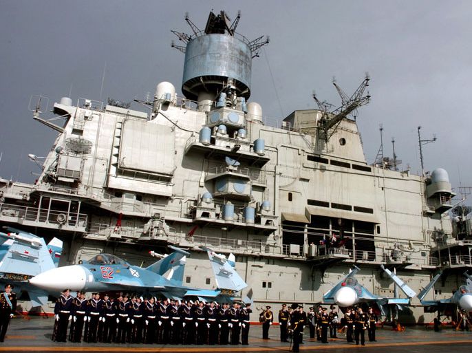A handout photo released by the official Syrian Arab News Agency (SANA) showing crew lined up aboard Russian aircraft carrier Kuznetsov in the sea port city of Tartous in Syria on 08 January 2012. A Russian flotilla has docked at the Syrian port of Tartus in a show of solidarity with the regime of President Bashar al-Assad, Syrian state media reported. The flotilla is to stay for six days at the port, according to the