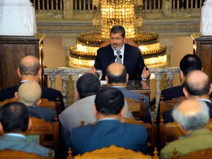 epa03286433 A handout picture released by the Egyptian Presidency shows president-elect Mohamed Morsi (C) meeting with leaders of Egyptian political parties, in Cairo, Egypt, 28 June 2012. Morsi, of the Muslim Brotherhood group that was banned under Hosni Mubarak, has become on 24 June Egypt's first freely elected president. He has promised an administration
