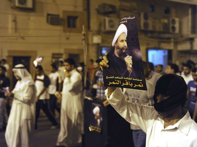 A protester holds up a picture of Sheikh Nimr al-Nimr during a rally at the coastal town of Qatif, against Sheikh Nimr's arrest July 8, 2012. Sheikh Nimr, a prominent Shi'ite Muslim cleric who was wanted by the police, was detained in Saudi Arabia's Eastern Province on Sunday over calls for more rights for the minority Muslim sect in the Sunni monarchy, his brother and an activist said