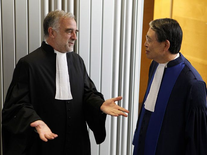 epa Luis Moreno-Ocampo, (L) speaks with Court President Sang-Hyun Song, after a swearing-in ceremony at The International Criminal Court (ICC) in The