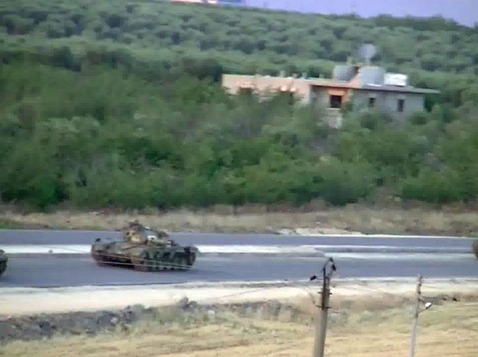 An image grab taken from a video uploaded on YouTube on July 10, 2012 allegedly shows tanks from forces loyal to the Syrian government in the town of Izaz, on the Turkish-Syrian border