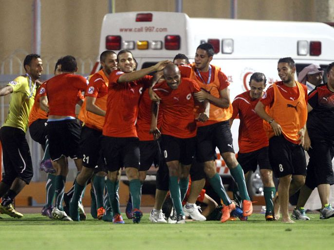 Libya's players celebrate with their captain Ahmed Osman (C) after he scored a goal against Saudi Arabia during their 2012 Arab Cup semi-final football match in the port city of Jeddah on July 3, 2012. AFP PHOTO/AMER HILABI