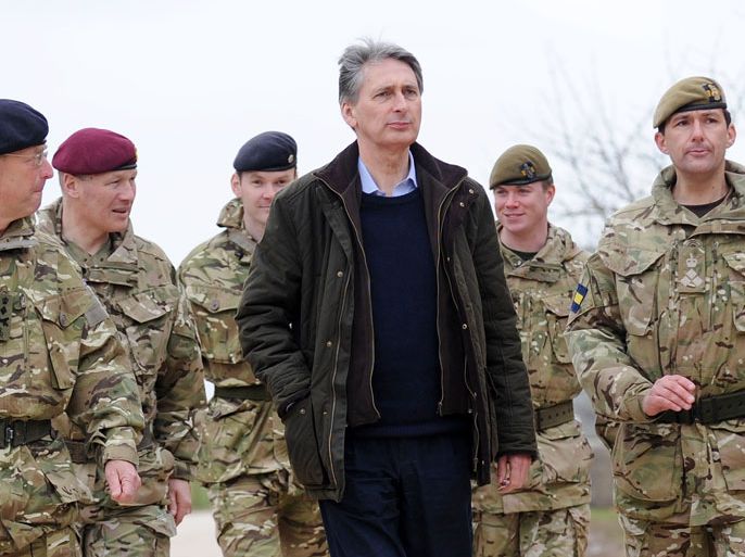 epa03138160 British Defense Secretary Philip Hammond (C) arrives at an army training base with Chief of Defense Staff, Sir David Richards (L) and Brigadier Commander Doug Chalmers (R) on Salisbury Plain at Copehill Down in Wiltshire, Britain, 09 March 2012. Others are not identified. Hammond paid a visit to British troops to support and wish them well before their deployment