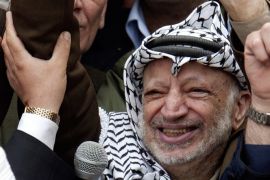 Palestinian President Yasser Arafat flashes a victory sign as he addresses supporters outside his headquarters in the West Bank city of Ramallah, in this April 24, 2004 file picture. A week after fresh allegations that their late leader Arafat was poisoned, Palestinian officials are still discussing behind closed doors when and how to exhume his body for examination. REUTERS