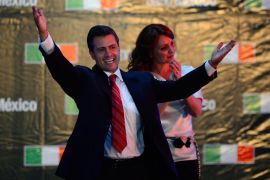Mexico City, -, MEXICO : The Mexican presidential candidate for the Institutional Revolutionary Party (PRI), Enrique Peña Nieto (L), accompanied by his wife Angelica Rivera, celebrates after learning the first official results of the presidential election, at the party's headquarters in Mexico City on July 1, 2012. Peña Nieto, the new face of the party that governed Mexico for seven decades, won Sunday's presidential election, according to first official results by the independent Federal Electoral Institute (IFE). Peña Nieto had around 38 percent of the vote against around 31 percent for his nearest rival, leftist Lopez Obrador from the Party of the Democratic Revolution (PRD), according to the early count. AFP PHOTO/Alfredo ESTRELLA