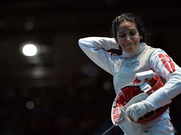 Tunisia's Ines Boubakri reacts after her defeat against Italy's Valentina Vezzali during their women's foil fencing quarterfinal bout as part of the London 2012 Olympic games, on July 28, 2012 at the ExCel centre in London. AFP PHOTO / ALBERTO PIZZOLI