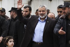 Senior Hamas leader Ismail Haniyeh (C) waves upon his arrival at Rafah Crossing in the southern Gaza Strip on 16 February 2012. Haniyeh returned to Gaza on 16 February from a tour during which he visited Iran and several Arab countries