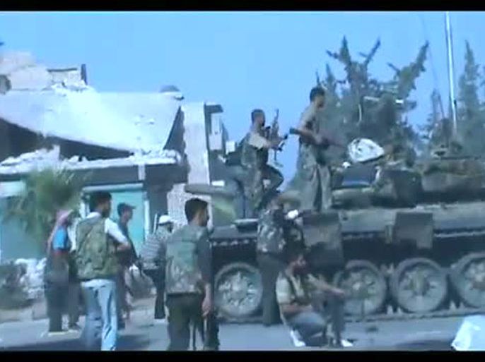 An image grab taken from a video uploaded on YouTube on July 23, 2012 shows Syrian rebel fighters battling government troops in the northern city of Aleppo. The rebel Free Syrian Army announced the start of the battle to "liberate" Aleppo, Syria's commercial hub and a traditional bastion of President Bashar al-Assad's regime. AFP PHOTO/YOUTUBE