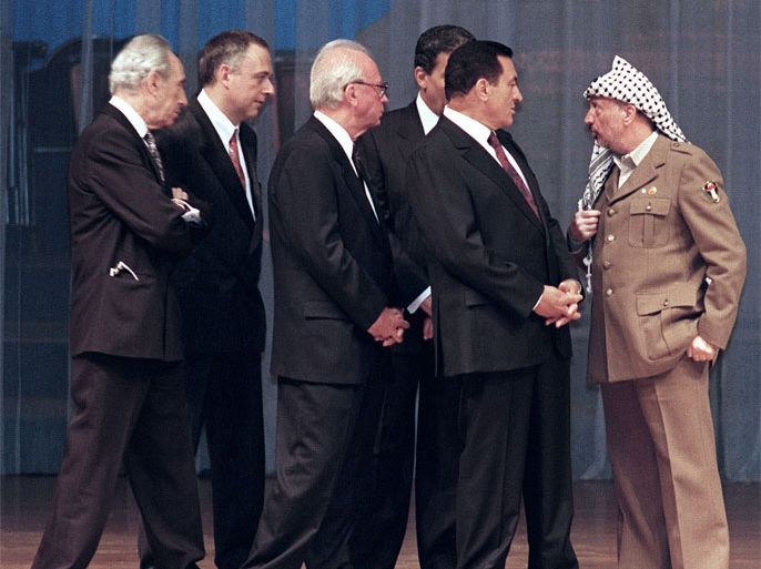Yasser Arafat (R), President of Palestine Liberation Organisation (PLO) addresses 04 May 1994 in Cairo (from left) Israeli Foreign Minister Shimon Peres, Russian Foreign Minister Vladimir Kosyrev, Israeli Premier Yitzhak Rabin, Egyptian Foreign Minister Amr Mussa (behind) and Egyptian President Hosni Mubarak as they pressure the PLO chairman who refused to sign a chapter of the Gaza-Jericho autonomy agreement. At right, US Secretary of State Warren Christopher looks on.