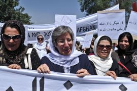 Kabul, -, AFGHANISTAN : Afghanistan head of Human Rights Commision Seema Samar (C) marches with Afghan women to protest the recent public execution of a young woman for alleged adultery, in Kabul on July 11, 2012. Dozens of Afghan women's rights activists took to the streets July 11 to protest the recent public execution of a young woman for alleged adultery, which was captured in a horrific video. AFP PHOTO/Massoud HOSSAINI