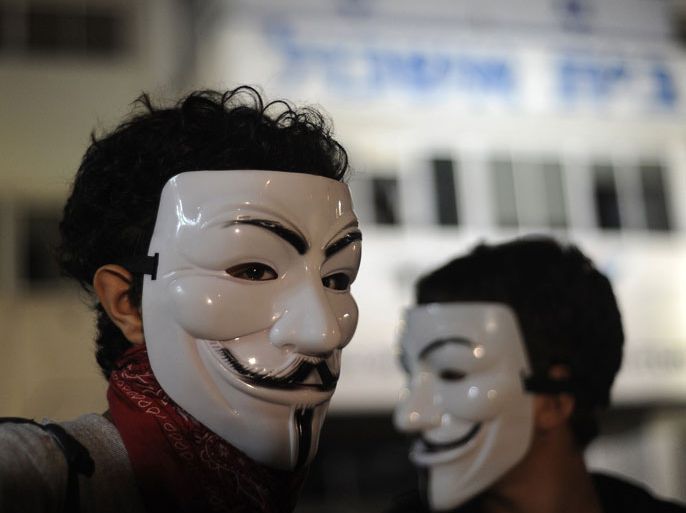 Tel Aviv, -, ISRAEL : Israeli protesters wear masks during a demonstration in Tel Aviv on July 21, 2012, in memory of Moshe Silman, an Israeli protester who set himself alight during a social justice demonstration on July 14. Silman struggled for his life after suffering from extensive burns and died at Tel Hashomer hospital near Tel Aviv, on July 20. AFP PHOTO/DAVID BUIMOVITCH