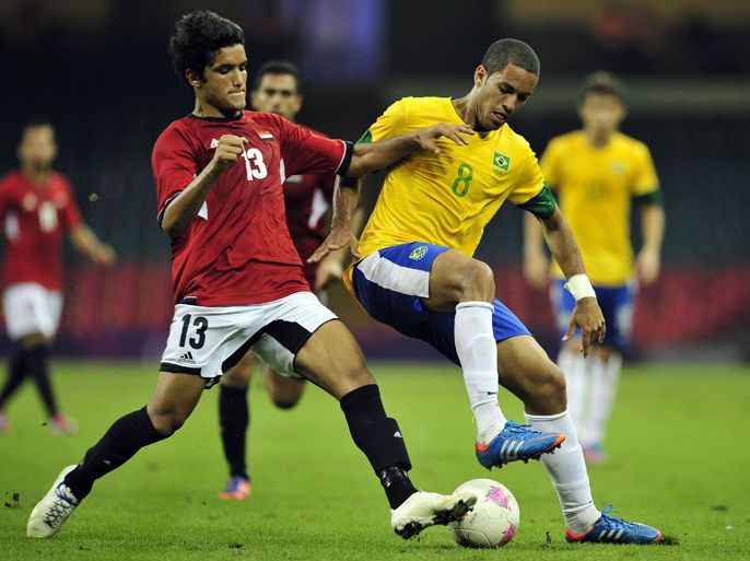 Brazil's defender Romulo (R) vies with Egypt's midfielder Shehab Ahmed (L) during the London 2012 Olympic Games men's football match between Brazil and Egypt at the Millennium Stadium in Cardiff on July 26, 2012. AFP PHOTO / GLYN KIRK
