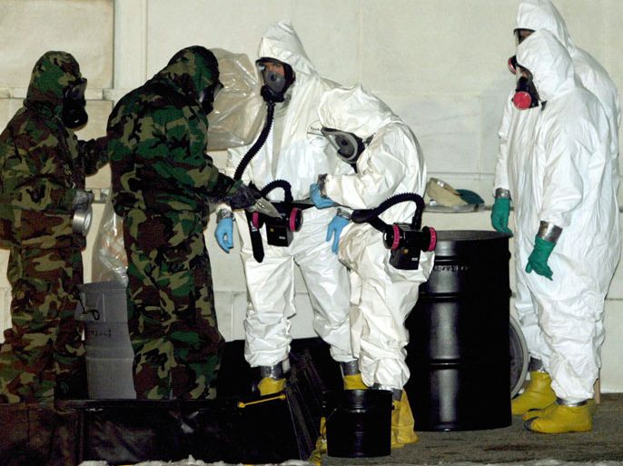 A chemical weapons team assembles outside the Russell Senate Office Building near the Capitol Building Wednesday 04 February 2004 in Washington, to place a plastic bag into a containment barrell. All Capitol mail will be decontaminated after the poison ricin was found in the Dirksen Senate Office Building. EPA/JOE MARQUETTE