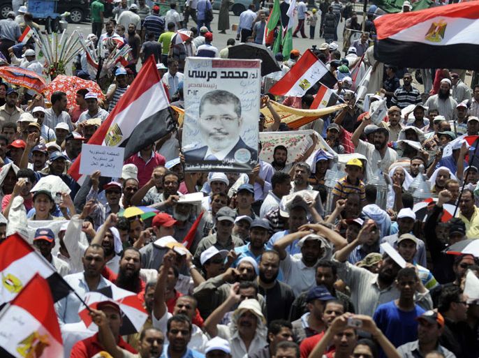 gyptian demonstrators show their support for President Mohamed Morsi during a protest in Cairo'sTahrir Square on July 13, 2012. Morsi will respect a court ruling overturning his decree for the dissolved Islamist-dominated parliament to convene, his office said amid a power struggle with the military. AFP