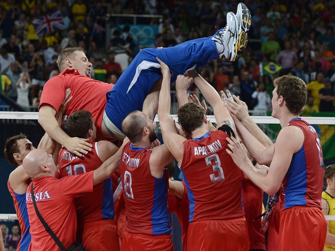 Russia's players throw coach Vladimir Alekno up into the air, as they celebrate winning the men's volleyball gold medal match of the London 2012 Olympics Games by defeating Brazil, in London on August 12, 2012. AFP PHOTO / MANAN VATSYAYANA