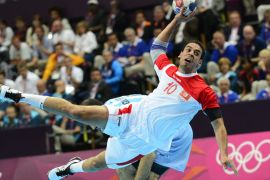 Tunisia's centreback Kamel Alouini jumps to shoot during the men's preliminary Group A handball match Argentina vs Tunisia for the London 2012 Olympics Games on August 6, 2012 at the Copper Box hall in London. AFP PHOTO/ JAVIER SORIANO