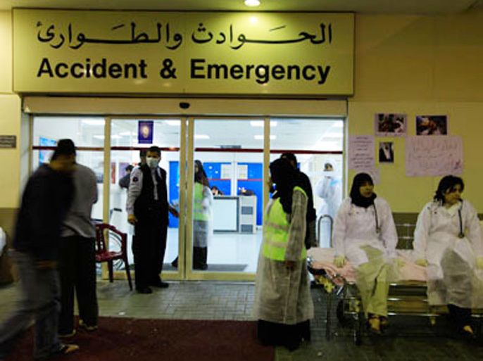 doctors and nurses wait outside the salmaniya hospital for any injured people to be brought in from riots in sitra, east of manama, march 15, 2011. a local man was killed on tuesday in clashes with police in the shi'ite muslim area of sitra and several others were wounded, an opposition parliamentarian said, as unrest continued to wrack bahrain
