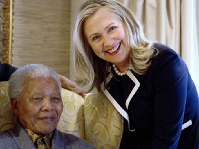 US Secretary of State Hillary Rodham Clinton meets with Nelson Mandela, 94, former president of South Africa, at his home in Qunu, South Africa, on August 6, 2012. Her private lunch with the Nobel Peace Prize winner was the first event of her South African visit, an indication of the prestige still enjoyed by the man who led the fight against white-minority rule. The two chatted in his home ahead of the meal, an honour that few receive as Mandela's health has become more fragile with age. AFP PHOTO/POOL/ Jacquelyn Martin