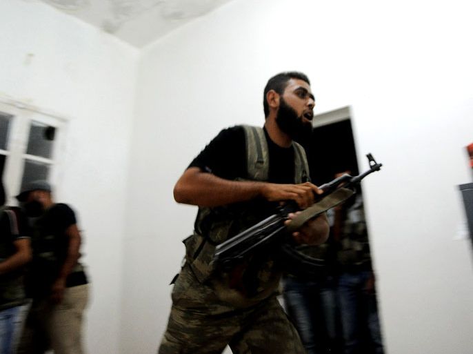 Syrian rebels take up their weapons during a government helicopter attack, at Tecvid Sicco military base north of Aleppo city, Syria, 24 July 2012. According to media reports on 24 July 2012, Syrian government forces had moved chemical weapons to airports near its borders, a day after the regime of President Bashar al-Assad warned that it could use them if Syria is attacked by an external force. President Bashar al-Assad's forces are currently still in full control of Syria's chemical weapons stockpile, Israel's military chief said on 24 July 2012. EPA/STR TURKEY OUT