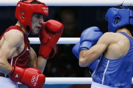 Ferhat Pehlivan (L) of Turkey defends against Ramy Elawady (R) of Egypt during their round of 16 Light-Flyweight (49kg) match of the London 2012 Olympic Games at the ExCel Arena on August 4, 2012 in London. Pehlivan was awarded a 20-6 points decision