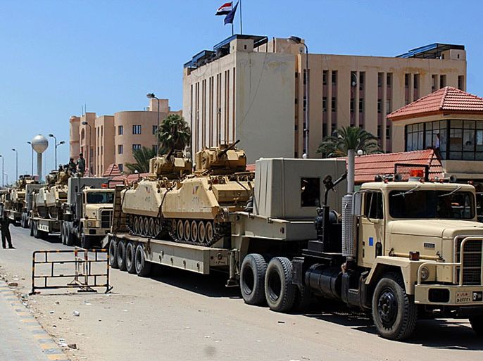 El-Arish, -, EGYPT : Egyptian miltary trcuks loaded with light tanks line up in el-Arish ahead of an operation to restore security in northern Sinai on August 9, 2012. Gunfire broke out in the Sinai town of El-Arish, reports said, as tensions simmered after the Egyptian authorities vowed to crush a surge in Islamist militancy in the tense peninsula. AFP PHOTO/STR