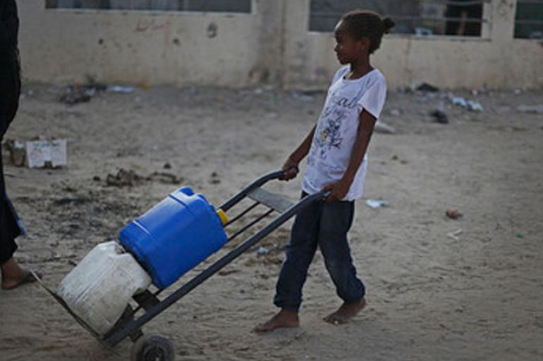 A Palestinian refugee transports water containers after filling them with water from a UN water station in Al-Shabora refugee camp in Rafah City on 11 August 2012. Reports state that the Shabora camp residents suffer from a lack of drinking water in homes, people turn to fill water from the water desalination plant to provide homes with water, which is from the International support for Gazans, and it's free for citizens. EPA/ALI ALI