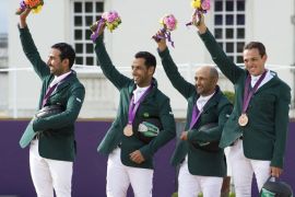 The Saudi team (from L) Prince Abdullah al Saud, Kamal Bahamdan, Ramzy Al Duhami and Abdullah Waleed Sharbatly (bronze) celebrate with their bronze medals on the podium of the team Show Jumping event of the 2012 London Olympics at the Equestrian venue in Greenwich Park, London, on August 6, 2012. AFP PHOTO / JOHN MACDOUGALL
