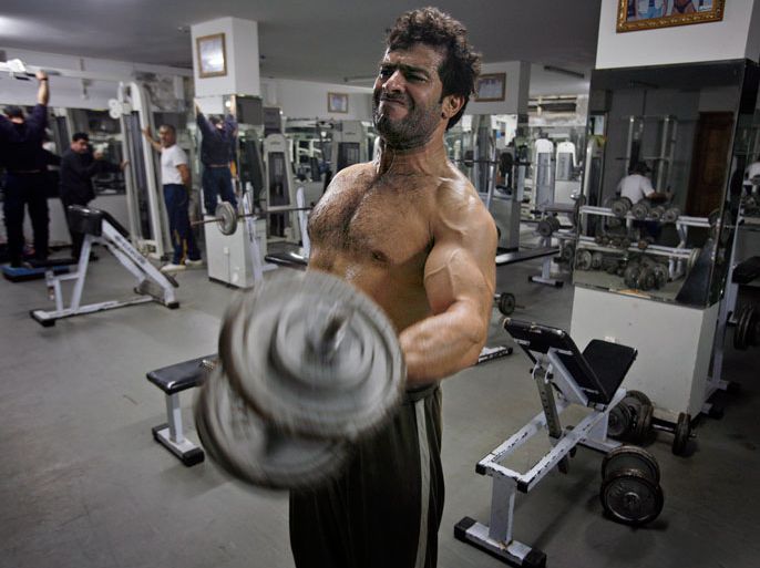 Palestinian bodybuilder Eyab Abu Hadi seen during a workout at the al-Saada gym in Gaza City, Gaza Strip, 21 February 2010. Many gyms in Gaza City that were closed during the Israeli-Palestinian war are again open and packed with young men bringing their bodies in shape. EPA/ALI ALI